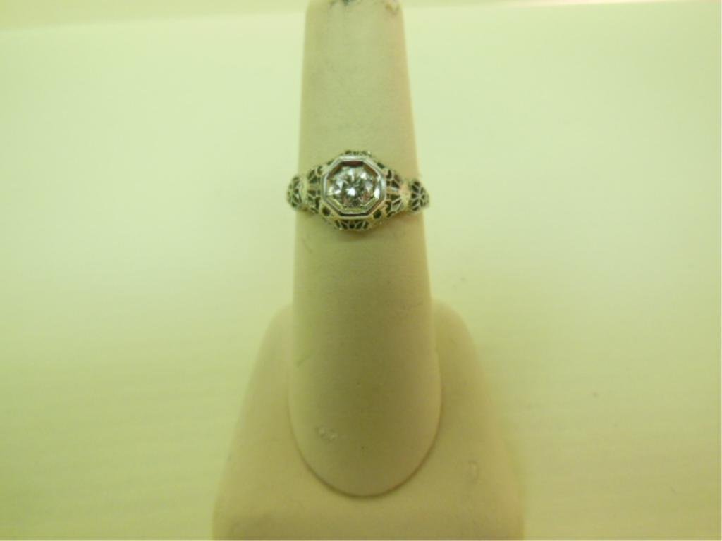 14k & Diamond Art Deco Lady's Ring: 14k white gold Art Deco diamond ring, filigree setting, tests 14k with a bezel set 40+ pt approximate, round solitaire diamond of good color and clarity, 1.4 DWT, size 7. [2] CONDITION: Very fine, wea