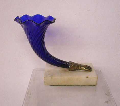 Victorian Glass Cornucopia Vase: Victorian 5" cobalt blue glass cornucopia vase set into a brass hand form and mounted on a white marble base, overall size is 6 1/2" x 7" x 3". CONDITION: Very good with small chips on marble base.