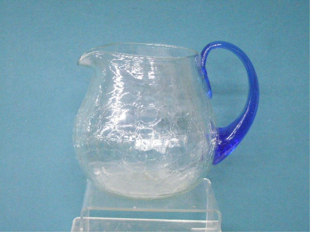 Vintage Blenko Glass Cider Pitcher: Vintage clear crackle Blenko glass 7 1/2" cider pitcher with applied blue glass handle. CONDITION: Very good with no damage.