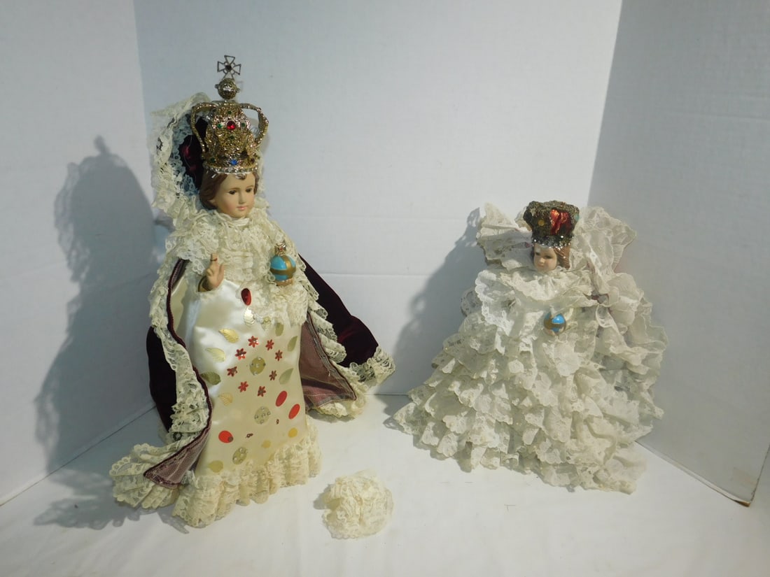 2 Infant of Prague Statues: Two Infant of Prague Statues, both plaster, Columbia statuary, made in Italy (paper label on bottom of both), elegant ruffled gown with jewel type crown on each, 13 1/2" and 17"h. CONDITION: Some pain