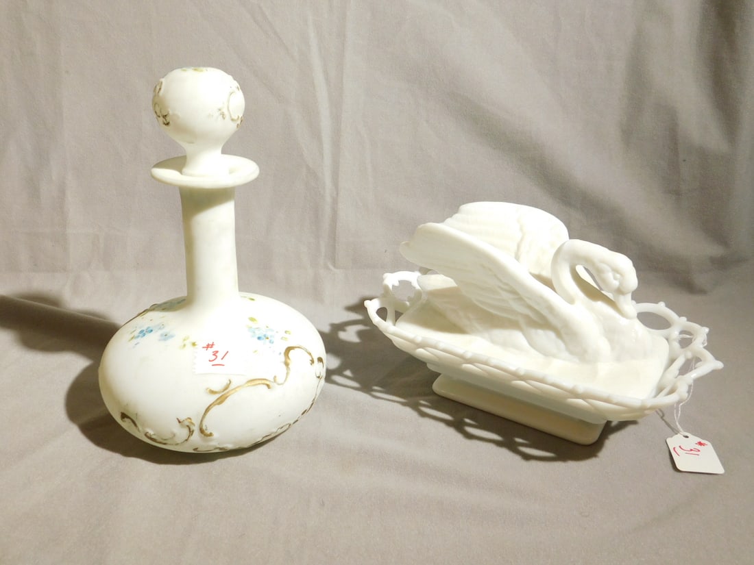 2 Antique Milk Glass Pieces: Two Antique Milk Glass Pieces, includes: swan sculptured covered server with open work border on base, 10" x 6" x 6", and a floral painted 9 1/2" blown glass decanter. CONDITION: Very good.