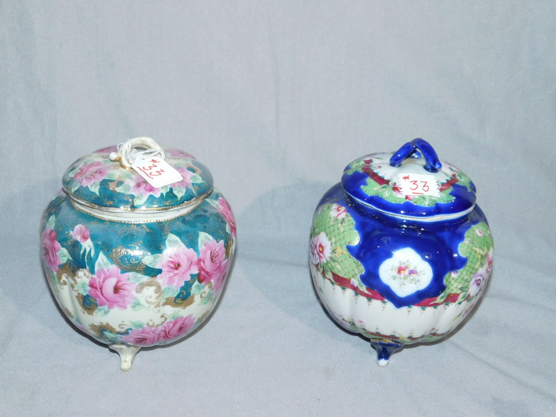 2 Nippon Covered Jars: Two Nippon Covered Jars, unmarked, hand painted porcelain, footed bulbous form, late 19th C, 8 1/2"h. CONDITION: Very fine.