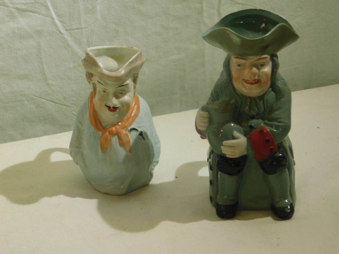 2 Toby Jugs: Two Toby Jugs, includes: painted 6 1/2" on blue / gray jasperware and a 5" painted porcelain, 19th C. CONDITION: Very fine.