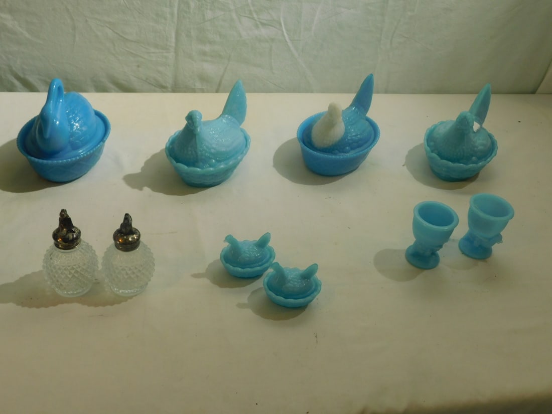 Blue Slag Glass Group: Blue Slag Glass Group, includes: three 5 1/2"l and two 2 1/2"l hens on nests, one swan on nest, two chicken egg cup and nine pairs of silver plate chicken crest clean glass salt and peppers. CONDITION