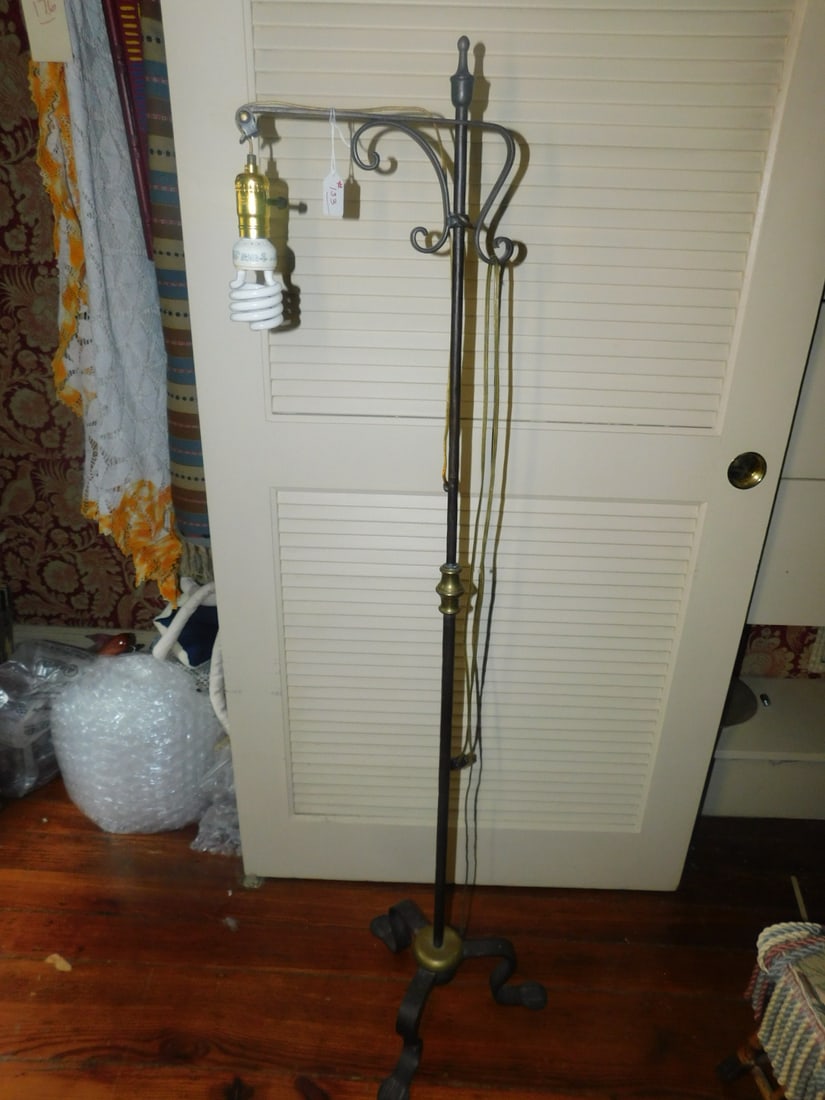 Iron Bridge Lamp: Iron Bridge Lamp, metal pole shaft with flat wrought iron bridge, brass finial, center accent and bottom cap, three wrought iron feet with flattened hammered bases, 57"h (no shade). CONDITION: Minor w
