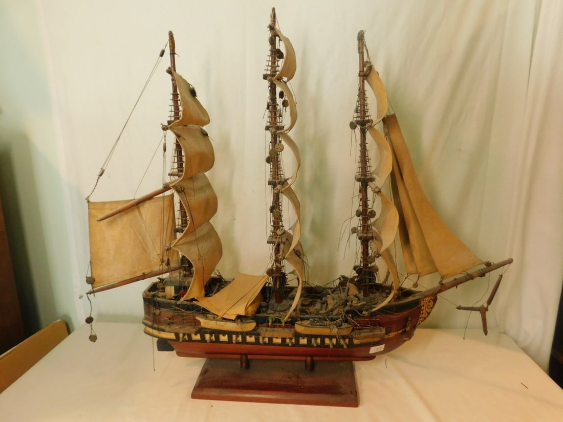 Wood Sailing War Ship Model: Wood Sailing War Ship Model, three mast square sails, side gun port along sides under rails, no name on side of ship, 34"l on two bottom poles and wood base. CONDITION: Jib boom detached (broken off b