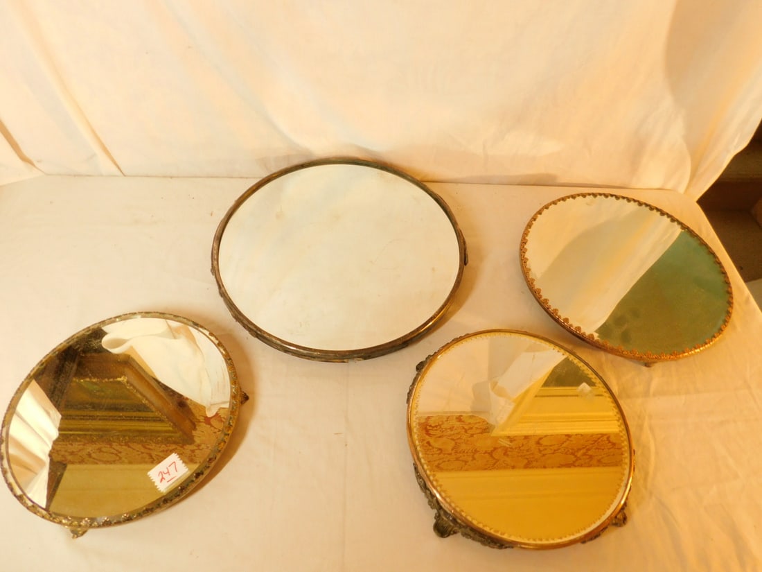 4 Victorian Plateaus: Four Victorian Plateaus, metal frames with beveled mirror inserts from 10" to 15"d. CONDITION: Light tarnish, 15" legs broken off and one set missing.