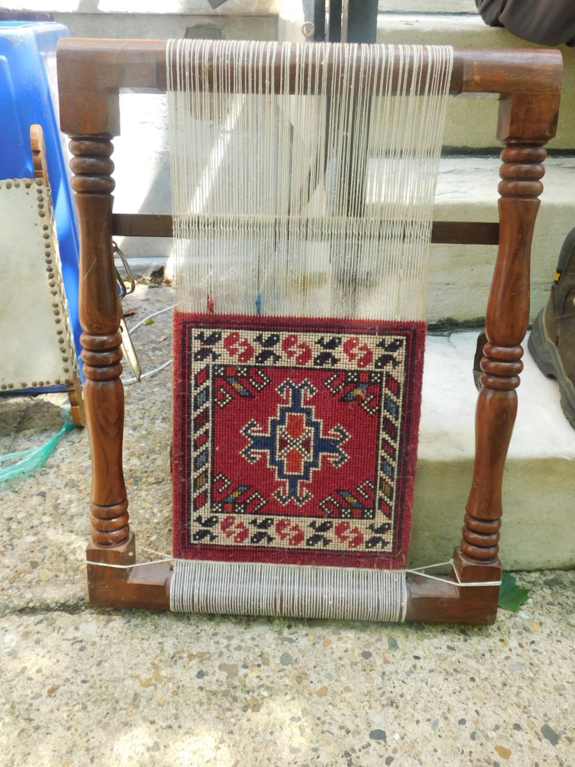 Rug on Loom: Rug on Loom, turned wood loom with a small flat weave mat, and scissors, mid 20th C. 16" x 21 1/2". CONDITION: Very good, some minor scratchy.