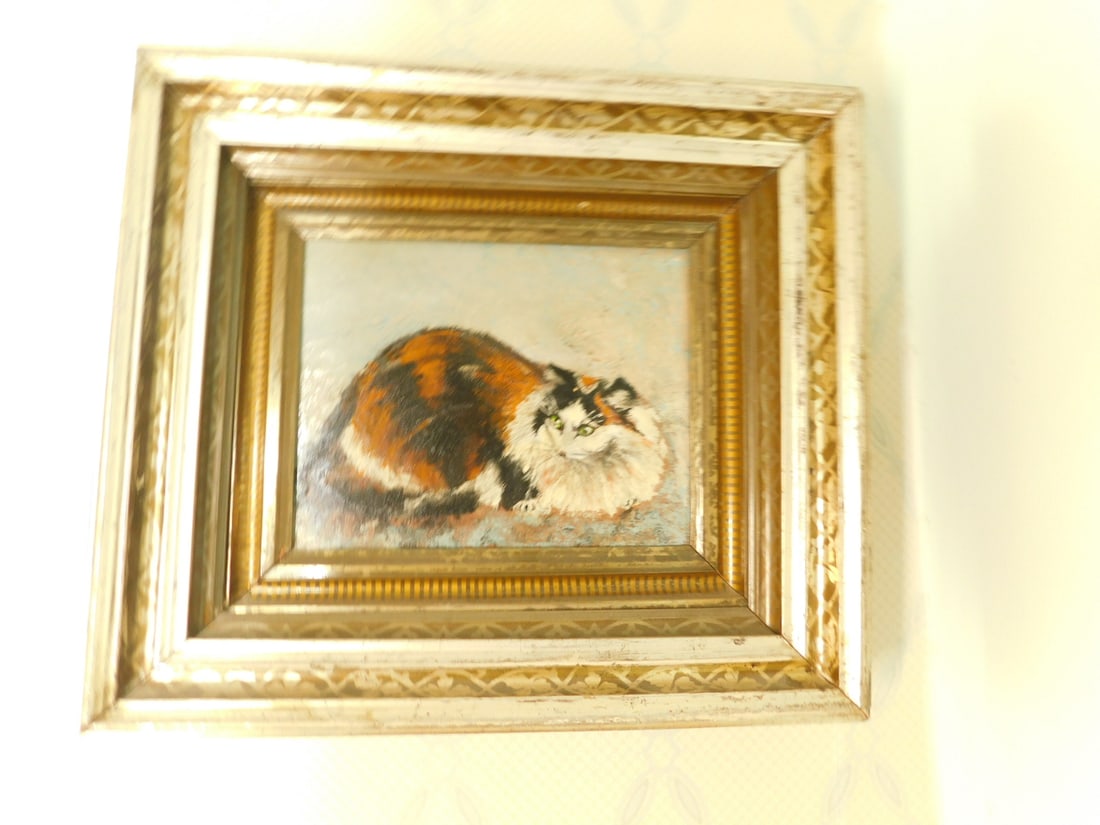 Cat Painting: Cat Painting, unsigned oil on canvas, reclining tabby cat in brown, black and white, image 8" x 10", circa late 20th, Victorian silver and gilt deep frame 14 1/2" x 17". CONDITION: Fading and light we