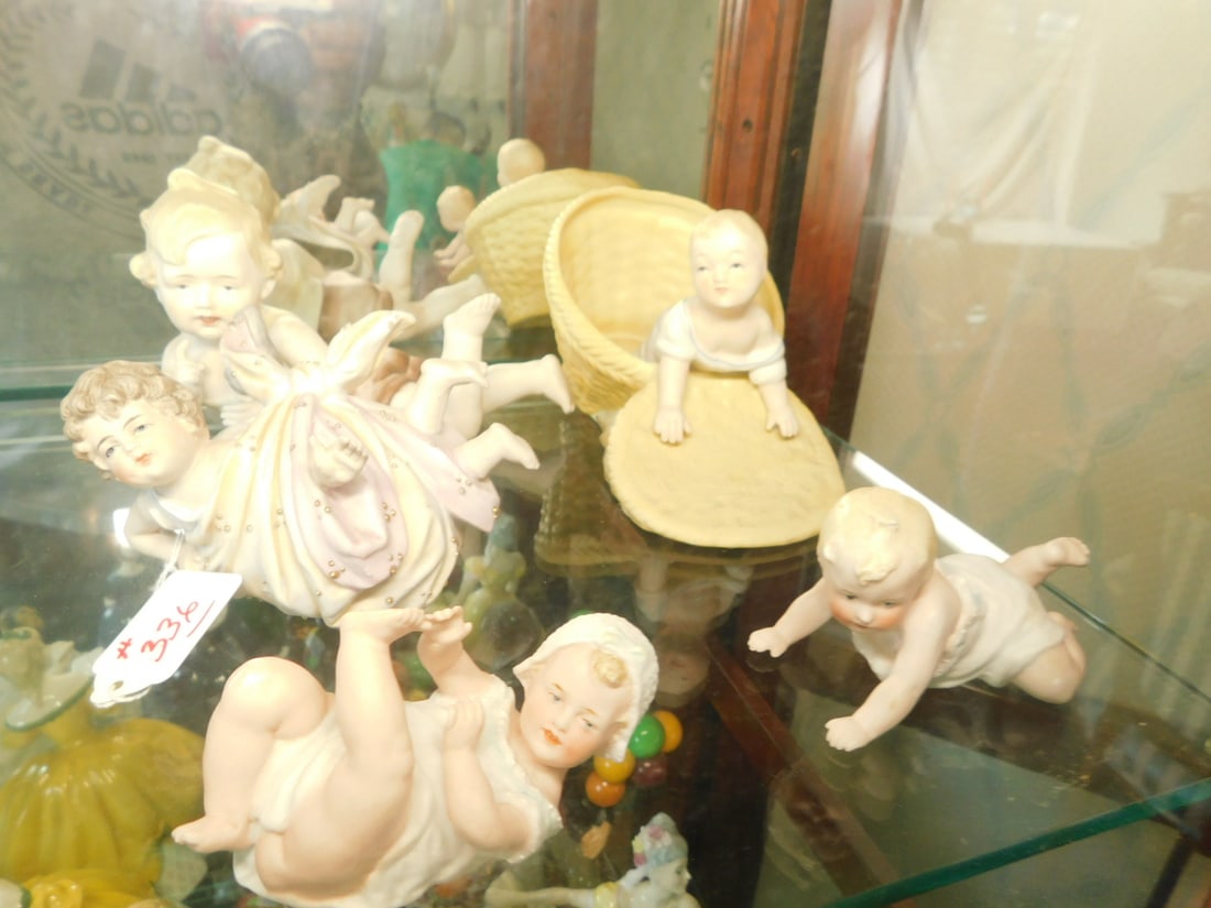 5 Bisque Piano Babies: Five Bisque Piano Babies, hand painted, various style, late 19th to mid 20th C, from 4" to 7"l. CONDITION: Very good.