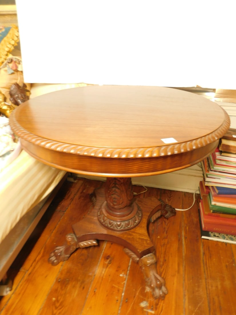 Classical Center Table: Classical Center Table, mahogany, gadrooned edge 32"d top, elaborate acanthus carved column on shaped platform with four winged hairy claw feet, 29 3/4"h, 19th C. CONDITION: Very good.