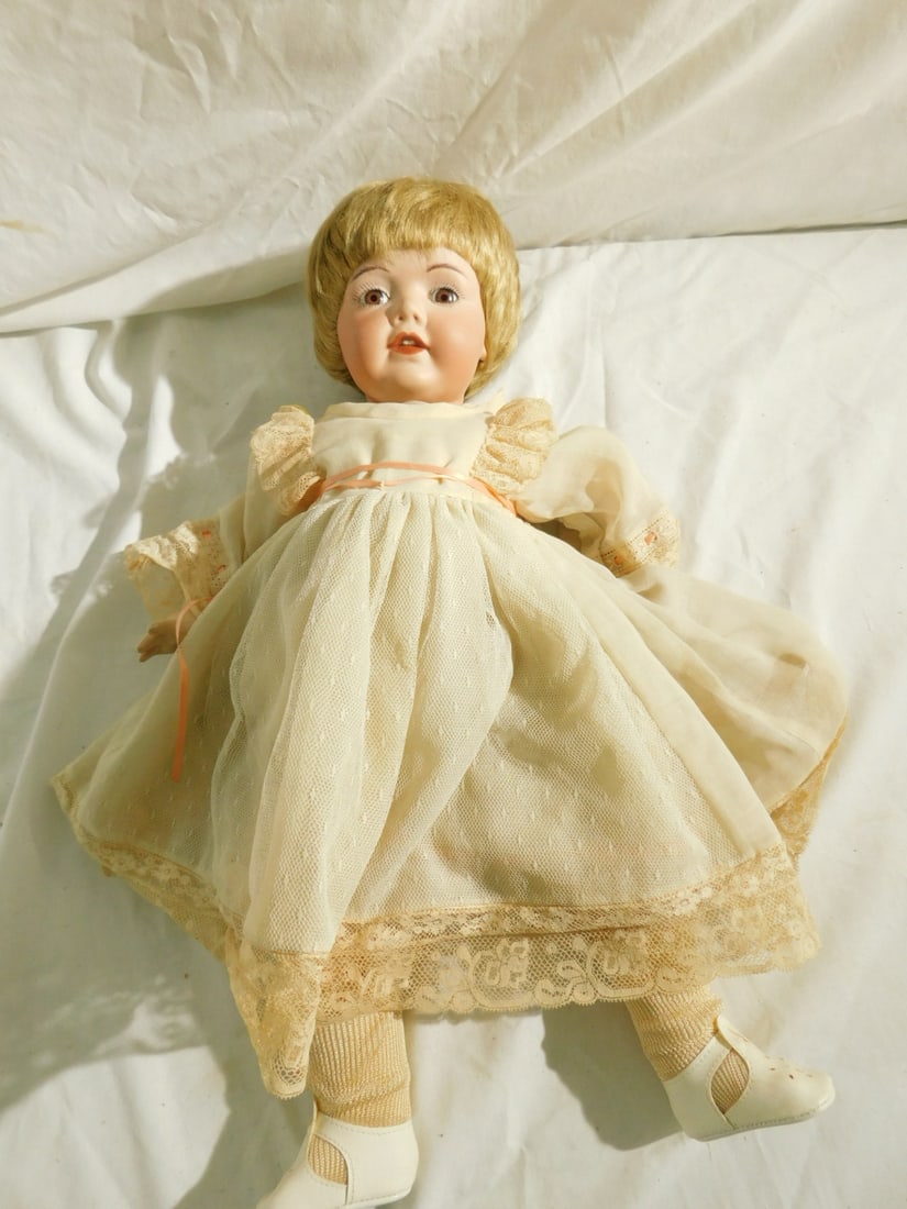 Bisque Head Doll: Bisque Head Doll "Nippon B-9" marked "CM" 1986 reproduction doll paper weight eyes, composition body, 18"l. CONDITION: Loose stringing.