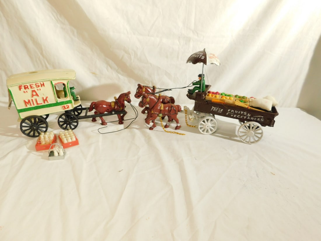 2 Vintage Cast Iron Wagons: Two Vintage Cast Iron Wagons both by P)rice, with original boxes including: fruit wagon, item #2016 and Fresh "A: milk wagon, both with drivers and supplies. CONDITION: Both pieces look unused, boxes