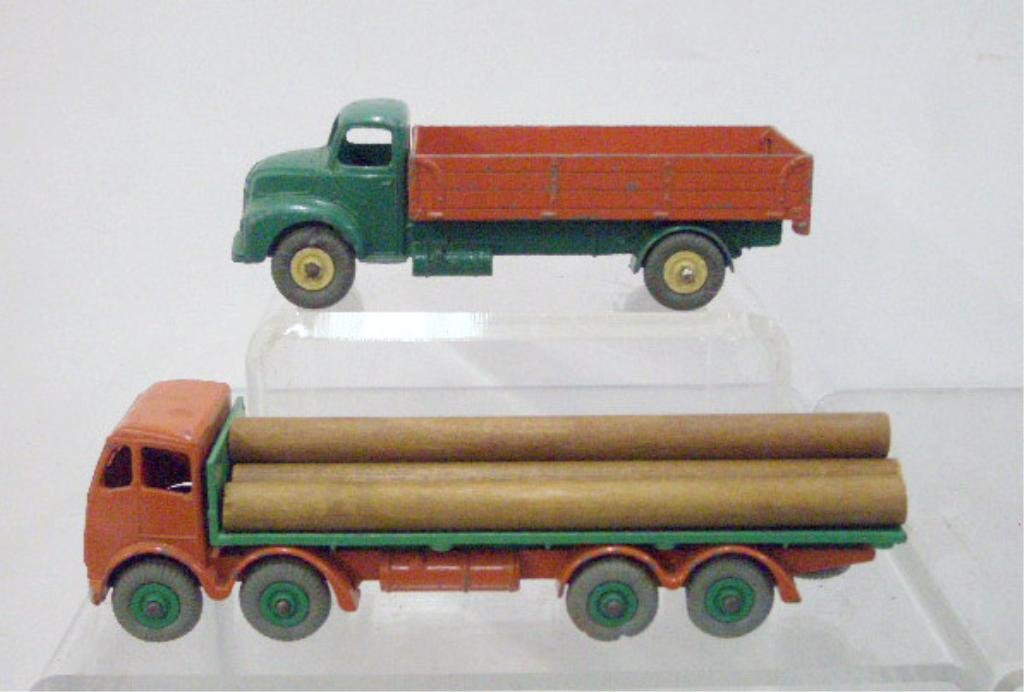 1960's Dinky Toys Flat & Cement Trucks: 1960's Dinky Toys die cast metal Supertoys Foden Flat truck and Leland Comet Cement truck. CONDITION: Both have areas with wear and or loss.