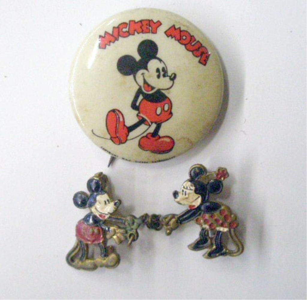 1930's Mickey & Minnie Mouse Pins: 1930's Mickey Mouse 1 1/4" celluloid Kay Kaman pin & 1" enameled Mickey & Minnie Mouse sweater pin. CONDITION: Mickey pin has wear & rust on back, sweater clasp pins are detached.