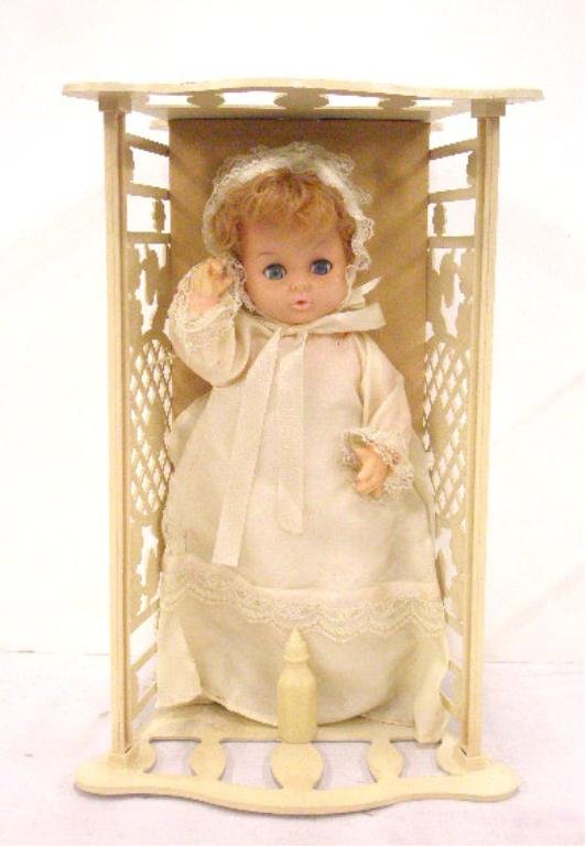1960's Drinks and Wets Baby Doll: 1960's vinyl face & hard plastic body 11 1/2" Drinks and Wets baby doll with sleep eyes in 15" x 7" plastic cradle, made in Taiwan. CONDITION: Very good with minor wear.