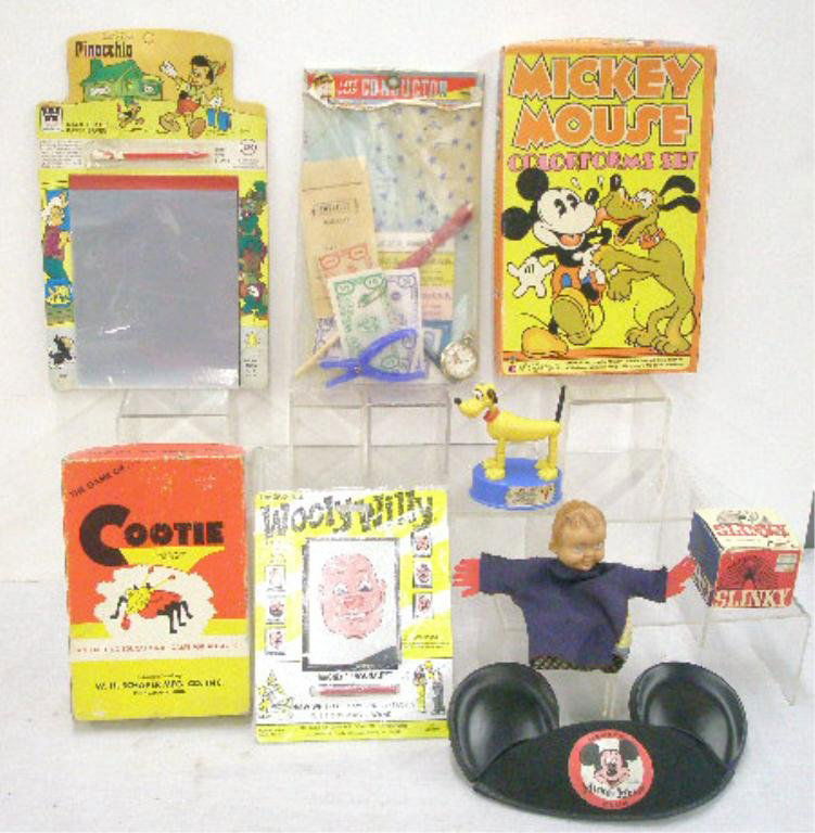 1950's-1970's Novelty Toys & Games: Lot of assorted 1950-1970's novelty toys & games, two face rubber head hand puppet, boxed Cootie game, Let's Play Conductor toy in package, Mickey Mouse Club hat, Kohner Pluto push-up puppet, Pinocchi