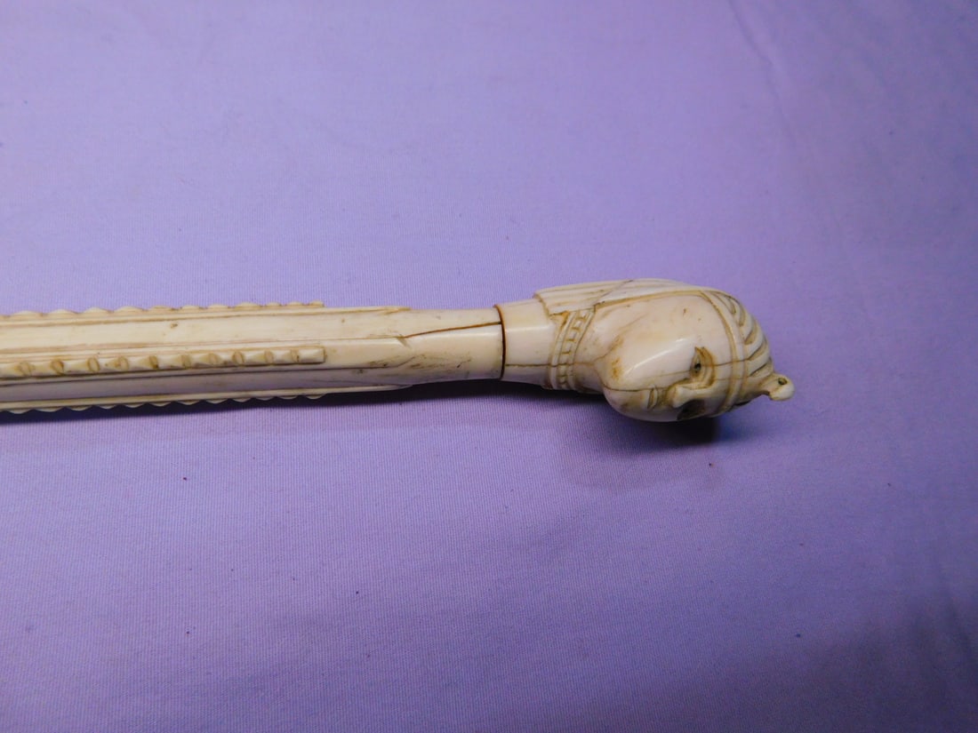 Egyptian Lady's Cane: Egyptian Lady's Cane, bone, possibly Japanese, head attached to a 7 1/4" long carved grip with turned collar, bamboo shaft, brass ferrule, early 20th C., 35"l. [12] CONDITION: A few expansion splits o