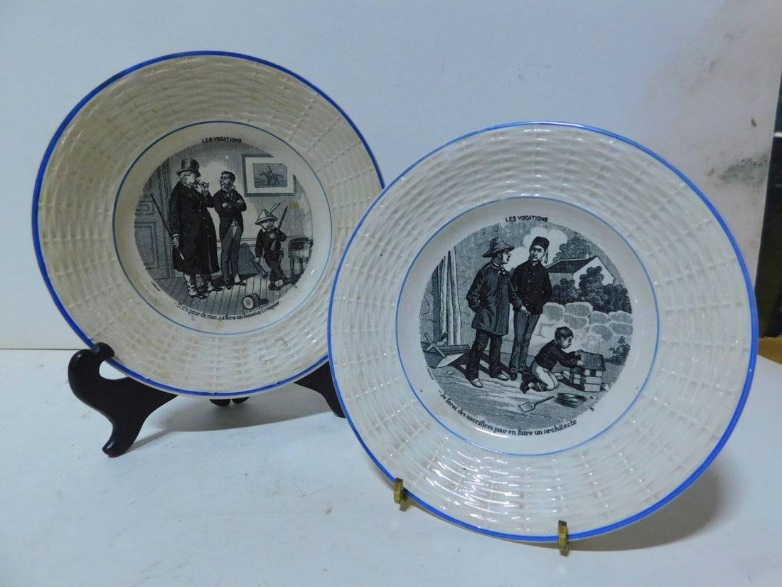 2 Sarreguemines Plates: Two Sarreguemines Plates, France, basket, weave bordered porcelain 7"d, black transfer figural scenes "Les Vocations". CONDITION: Very fine.