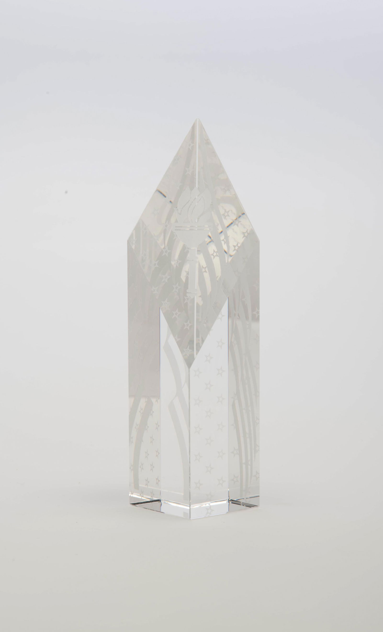 Glass Patriotic Obelisk: Glass Patriotic Obelisk, unsigned, clear glass with etched glass stars and stripes, flag and torch, 7 3/4" x 1 7/8" x 1 7/8". CONDITION: Very fine.