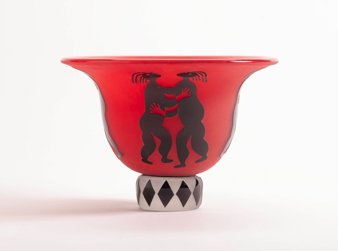 Raabe Signed Bowl: Raabe Signed Bowl on base, Fi??, '97, red mat finished glass bowl with raised black glass dancing figures on a frosted and black glass diamond pattern base, 8 7/8"d, 6 1/4"h, from the Bella Kaufman co