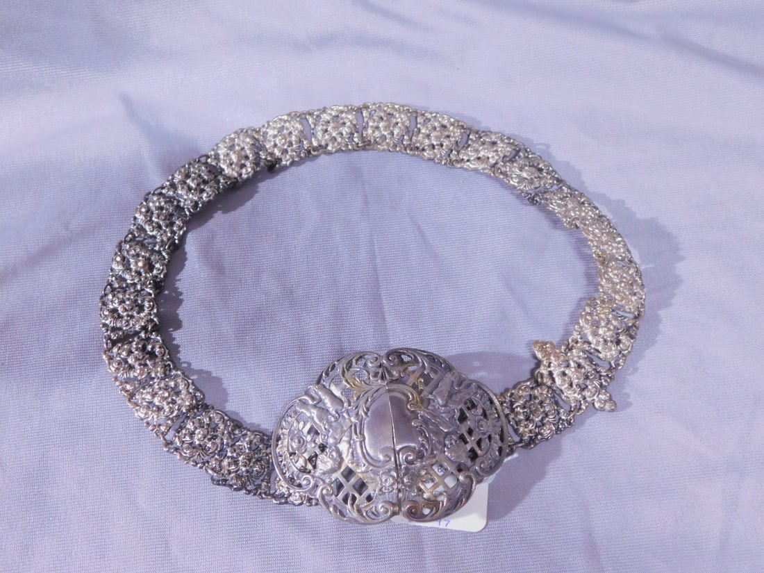 Silver Bride's Wedding Belt: Silver Bride's Wedding Belt, 800 silver - Germany, 23"l floral and scroll embossed open work, 1" wide belt holds a two part buckle of relief cast Putti with cartouche lattice work and scroll and rose