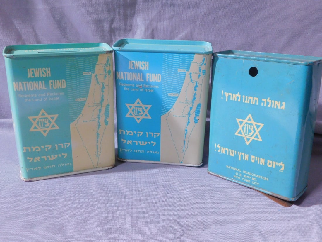 3 Tzedakah Boxes: Three Tzedakah Boxes, lithographed tin; includes: one "Jewish National Fund", marked one Keren Shalom chest, and one pre 1947. [78] CONDITION: Used, No keys, one with bent lock.