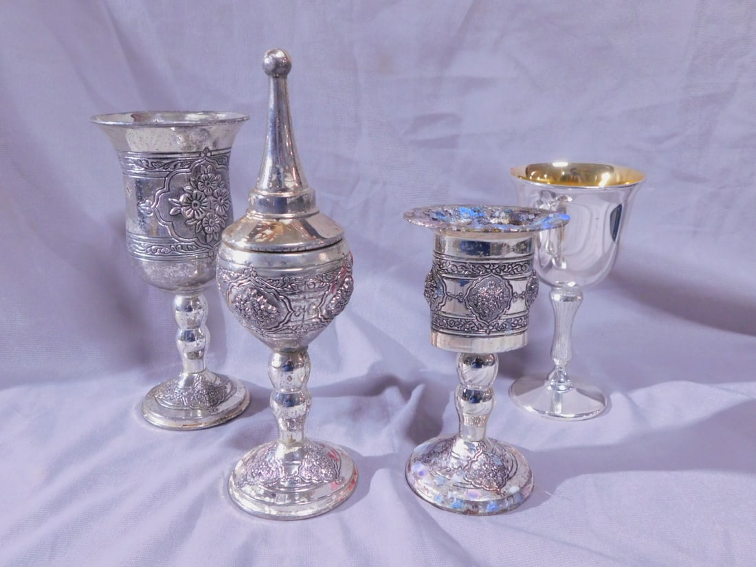 Havdalah Set: Havdalah Set, silver plated metal, cast floral and grape cluster designs, includes: matching candleholder and spice tower, 7 1/2"h, unmatching 5 1/4" and 6 1/4" wine goblets.[83] CONDITION: Good, used