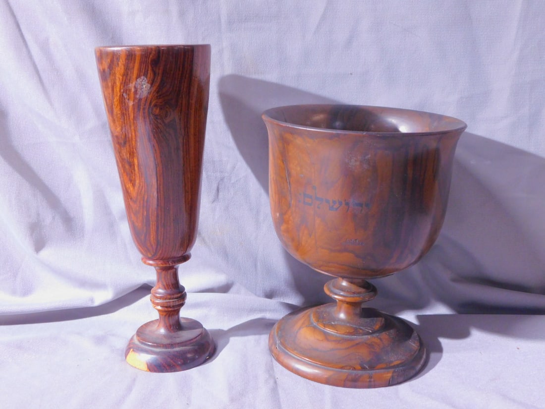 2 Olive Wood Vessels: Two Olive Wood Vessels, includes: large early 20th C "Jerusalem" marked goblet, 5 1/4"d, 6 1/2"h; and a traditional style, Pilsner shape 8 1/4"h goblet mid 20th C. [98] CONDITION: Pilsner very fine, l