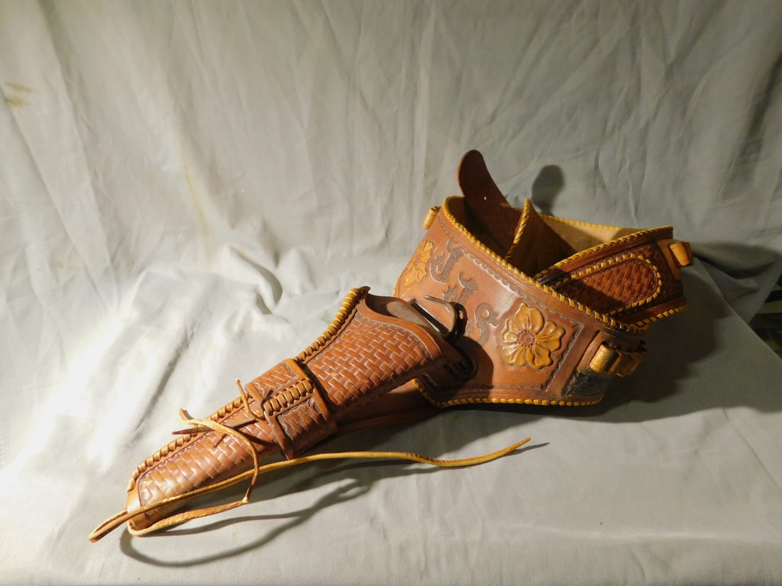 Cowboy Gun Belt /Holster: Cowboy Gun Belt /Holster, canned tooled brown leather with flower buds and monogram "JJS"? brass buckle. CONDITION: Lightly used, modest wear.