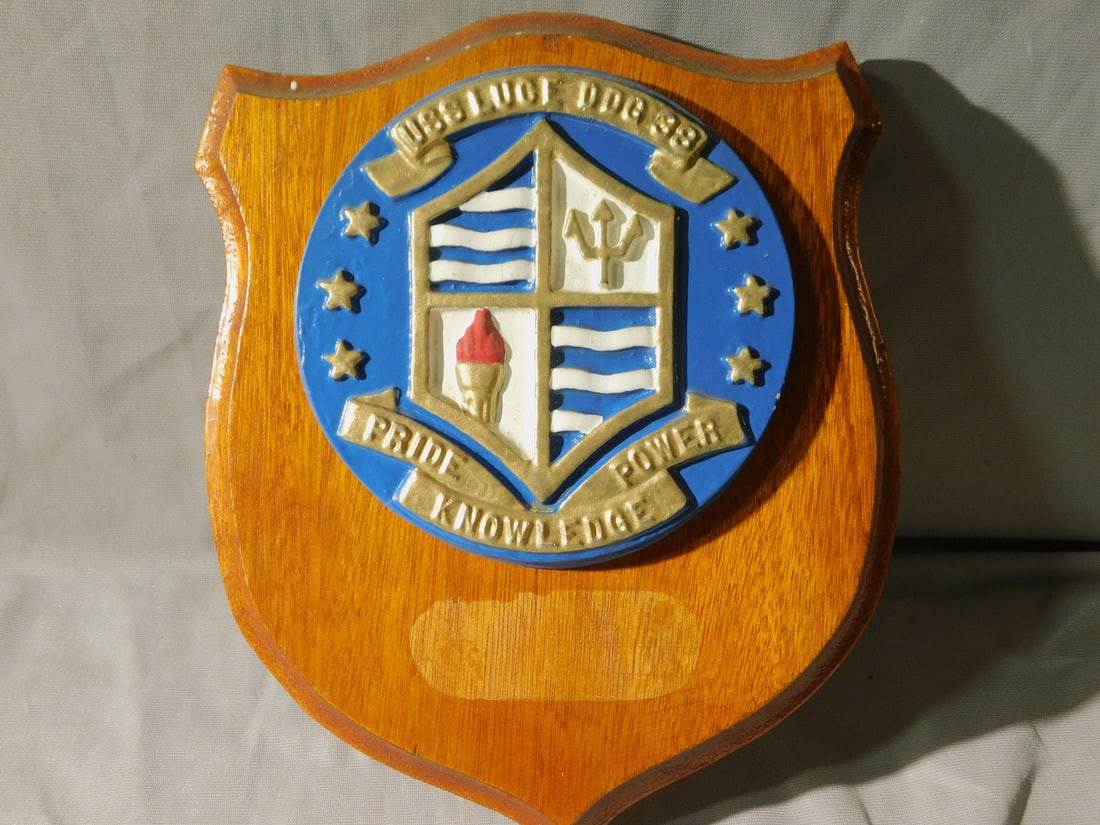 Bronze Painted U.S. Navy Ship Plaque: Bronze Painted U.S. Navy Ship Plaque, U.S.S. Luge, DDG -38, Pride, Power,Knowledge gold accent over blue background, with trident waves, torch and stars, 5 3/4"d on a wood shield form back, 8 1/2" x 1
