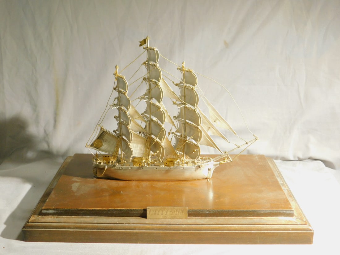 Sterling Silver Cutty Sark Ships Model: Sterling Silver Cutty Sark Ships Model, mounted on a 10 1/2" x 17 1/2' wood base, gold overlay rigging lines, anchor and accents, marked Mexico sterling on back rail with a attached disc marked Silver