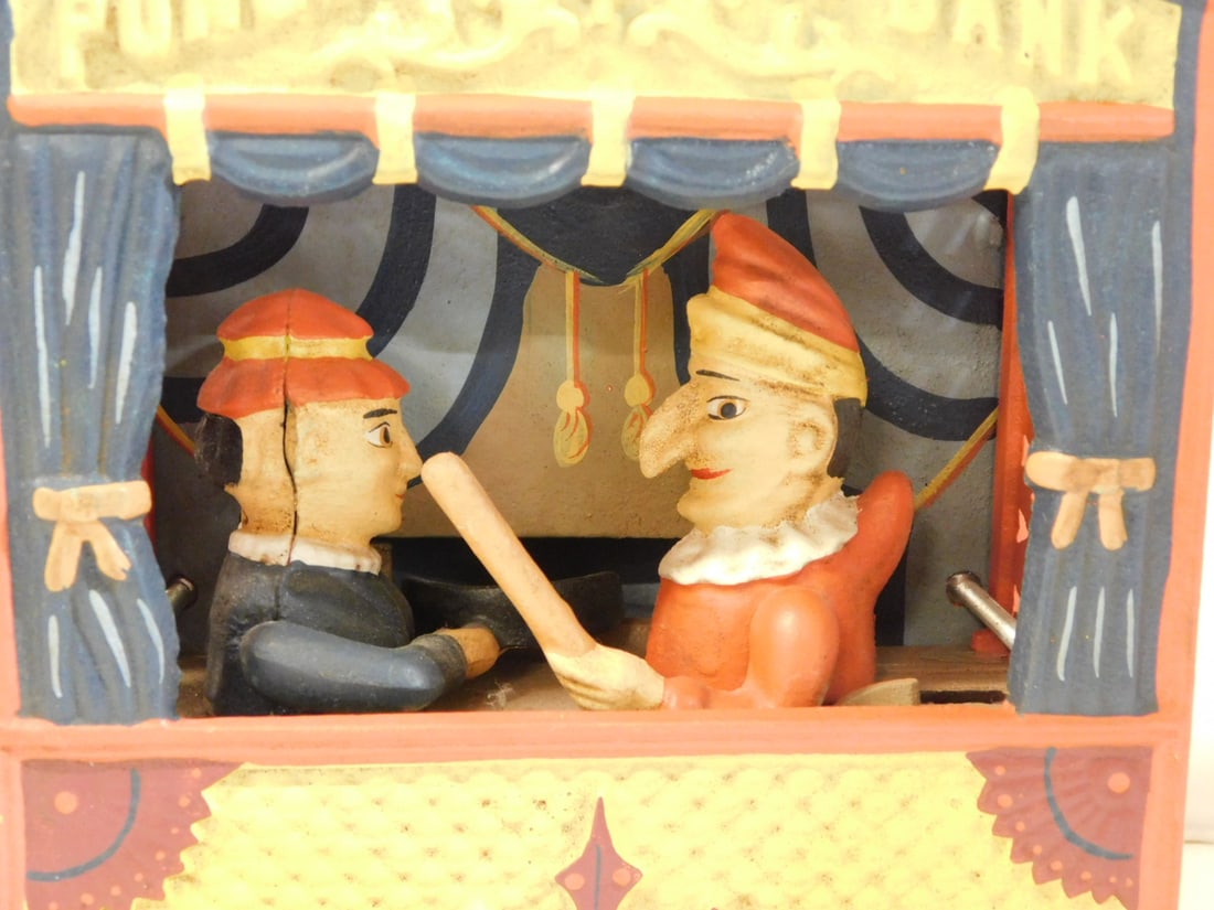 Punch and Judy Bank: Punch and Judy Bank, cast iron reproduction, 6 1/4" x 7 1/2" x 4". CONDITION: Very fine.