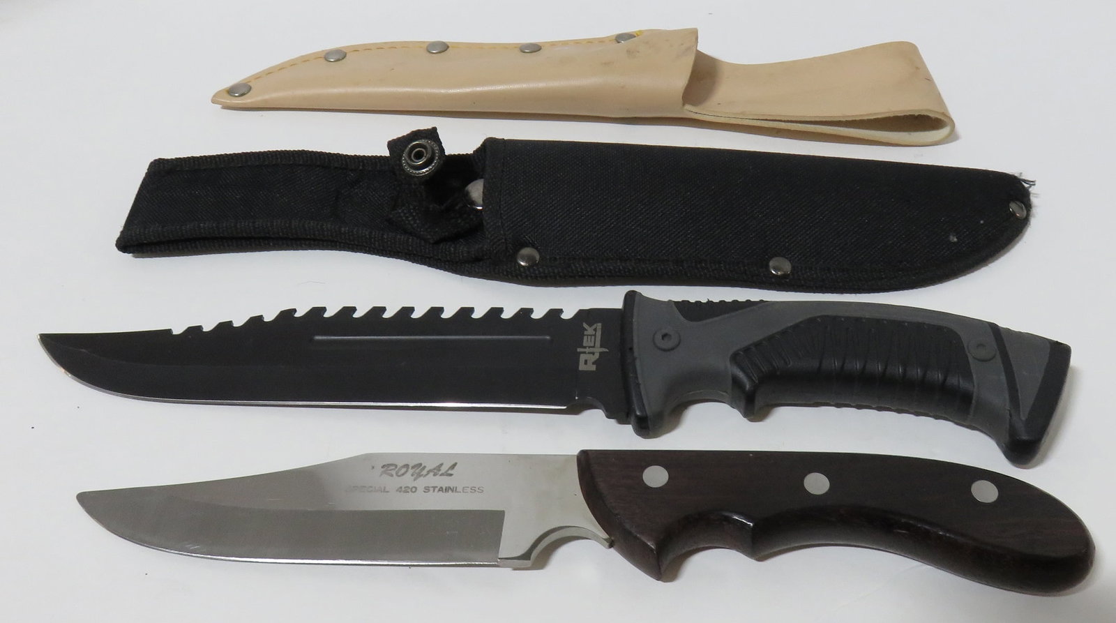 Hunting and Combat knives: Hunting and Combat knives, one each including: R-Tek 12 1/2" black Combat knife, SKU: RT210273-BK, with rubber handle and saw tooth back, stainless steel blade with black canvas sheath, plus, Royal Sp