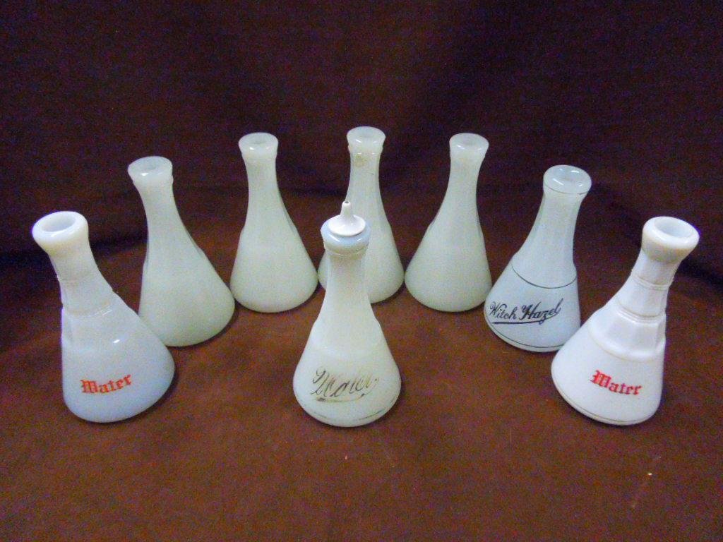 Antique Glass Barber's Bottles: Lot of eight assorted antique clambroth & milk glass Barber's bottles, includes: Witch Hazel, 3 water & 4 unmarked. CONDITION: All have minor wear.