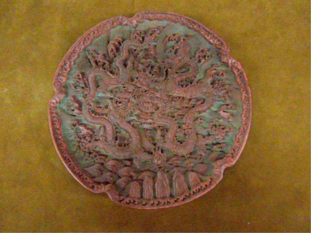 Chinese Cinnabar Plate: Chinese Cinnabar plate, dragon motif, 20th c. diameter 9 3/8". [31] CONDITION: No issues identified.
