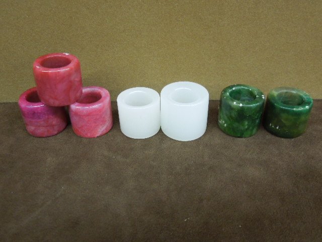 Seven Chinese Archer's Rings: Seven Chinese archer's rings, red and green soapstone, 20th C. [24]
