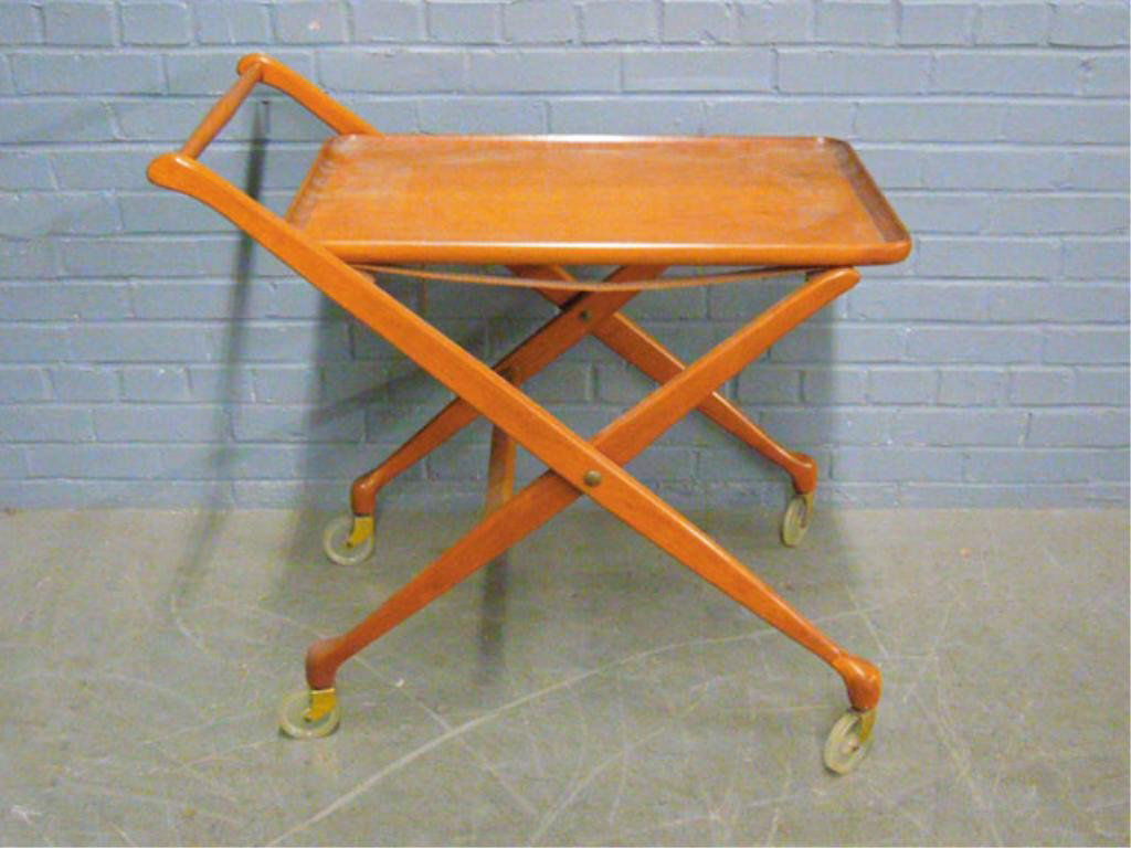 Danish Modern Tea Cart: Tea Cart, Danish Modern, cherry, features molded edge lift off tray top on fold up base, c 1960. 32"W x 30"T x 18"D. CONDITION: One leather strap broken.