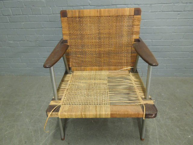 Mid Century Modern Arm Chair: Mid Century Modern Arm Chair, Rosewood & chromed steel, caned seat & back, rosewood leg tips with twin peak. C. 1950. 29" x 32" x 27". CONDITION: Missing Rosewood block on seat corner, needs recaning.