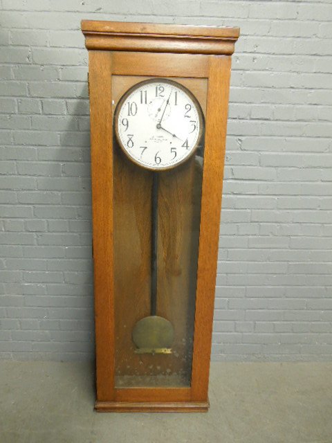 Master Unit School Clock: Master Unit School Clock, by International Time Recording Co. of New York, Oak case, electric, early 20th c. 21 1/4" x 8 1/4" x 63". CONDITION: Frayed wire, working condition unknown.