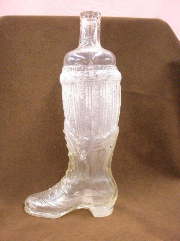 19th c. Boot Form Glass Bottle: 19th c. clear glass 12" Victorian lady's boot form bottle. CONDITION: Residue on inner portion, imperfection scratch on right side of shoe.