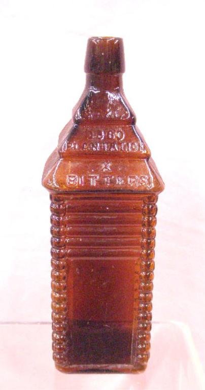 19th c. Drakes Plantation Bitters Bottle: 19th c. Drakes Plantation amber glass 10" Bitters bottle, patented 1860. CONDITION: Very good with wear & scratches on base, no damage.