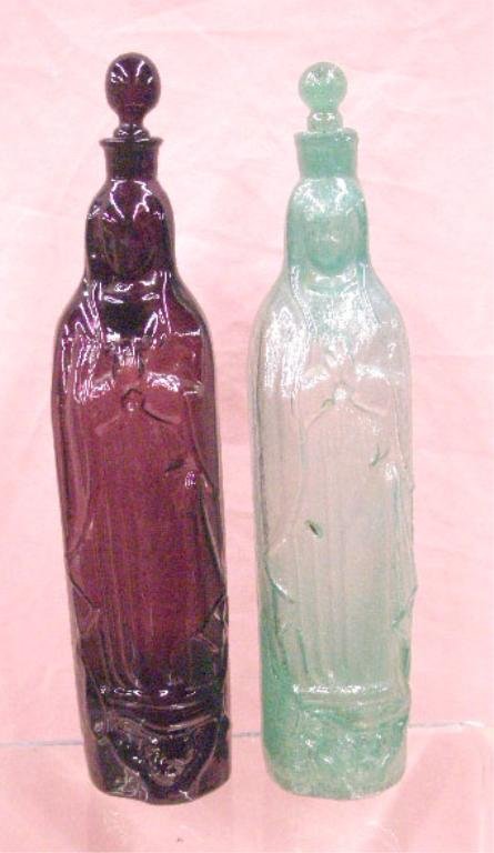 Vintage Glass Our Lady of Guadalupe Bottles: Vintage hand blown amethyst & turquoise colored glass Our Lady of Guadalupe 14" handled bottles, amethyst with original partial label on base. CONDITION: Both have rough pontil marks on base & no dama