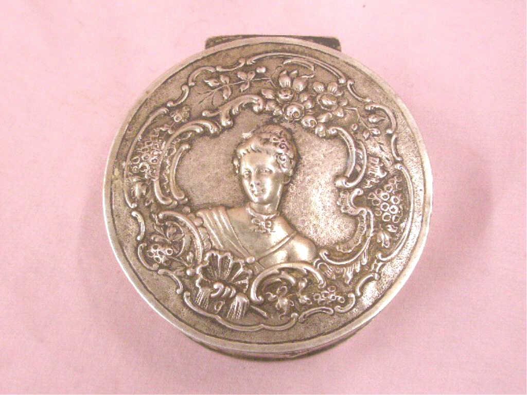 Antique Continental Silver Dresser Box: Late 19th/early 20th c. Continental silver hallmarked 1 1/4" x 3 3/8" dresser box, hinged lid with embossed female head, floral and grape embossed sides, 5.80 troy ounces. CONDITION: Very good with mi