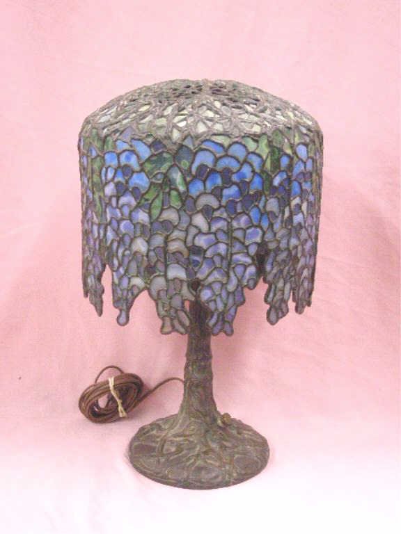 Reproduction Tiffany Studios Bronze Lamp: Reproduction Tiffany Studios bronze and leaded glass 15" table lamp. CONDITION: Works, very good with no damage.