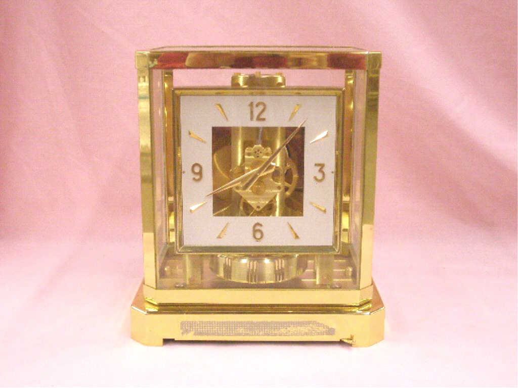 Jaeger LeCoultre Atmos Clock: Vintage Jaeger LeCoultre brass and glass cased 9 1/2" x 8 1/4" x 6" perpetual Atmos mantle clock. CONDITION: Not known if it works, tape residue on front bottom panel, minor wear.