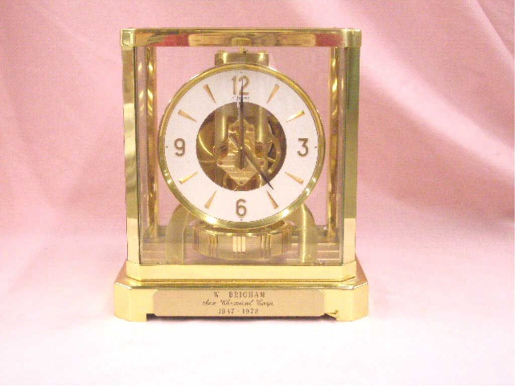 Jaeger LeCoultre Atmos Clock: Vintage Jaeger LeCoultre brass and glass cased 9 1/2" x 8 1/4" x 6" perpetual Atmos mantle clock. CONDITION: Not known if it works, presentation plaque applied on front bottom panel, minor wear.