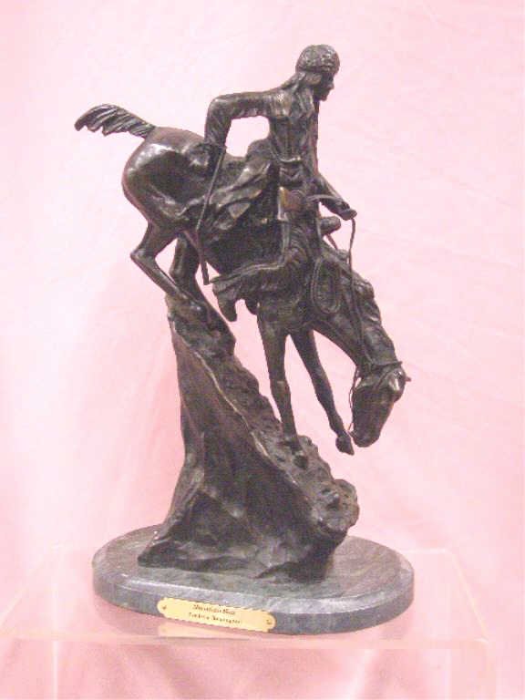 Frederic Remington Mountain Man Bronze Statue: Contemporary Frederic Remington 13" x 8" Mountain Man bronze statue on green marble base. CONDITION: Very good with minor wear and no damage.