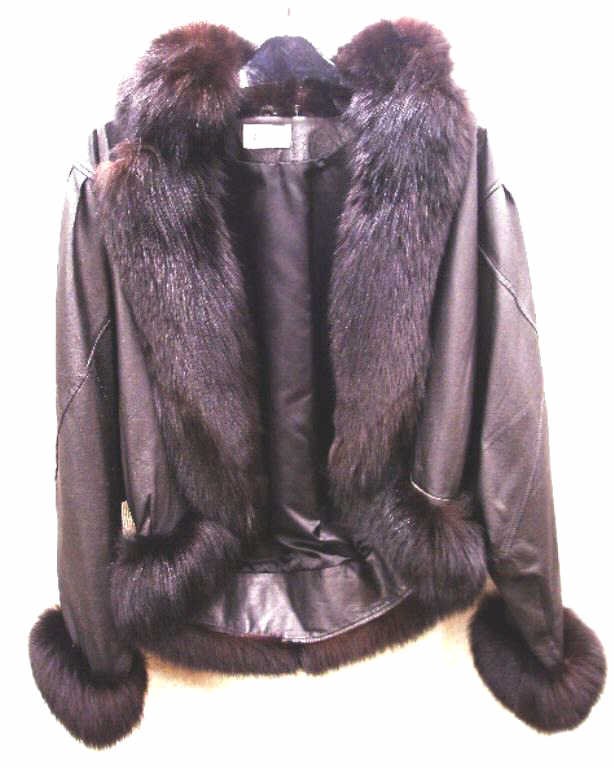 Oleg Cassini Leather Jacket: Modern era Oleg Cassini ladies leather and fox fur trimmed jacket, size medium. CONDITION: Very good with minor wear from usage.