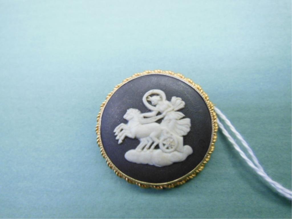 14k Wedgwood Brooch: 14k Wedgwood Brooch, 14k y gold rope edge round frame with a black & white jasperware inset of chariot rider with horses; verso "Wedgwood Made in England 59 GF", diameter 30mm. CONDITION: Bent pin, ot